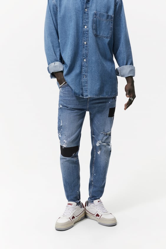 SPLATTERED RIPPED SKINNY JEANS